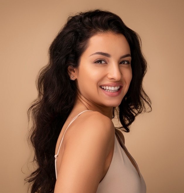 Beautiful,Brunette,Long haired,Young,Indian,Woman,Posing,On,Beige,Studio